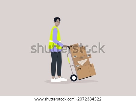 A young male Asian storage worker wearing a high visibility yellow vest