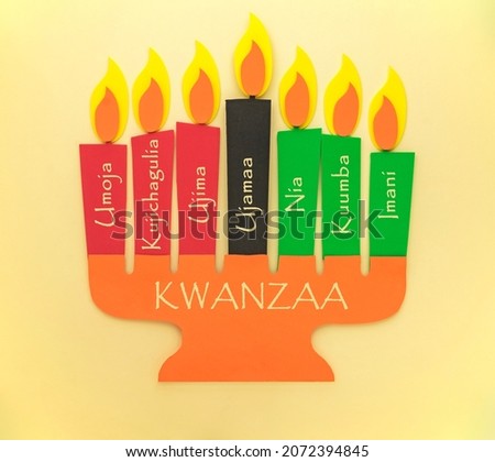 Candleholder made from paper with Kwanzaa Principles in Swahili - Unity, Self-Determination, Collective Work and Responsibility, Cooperative Economics, Purpose, Creativity, Faith