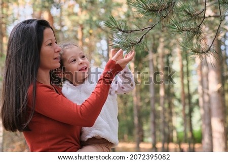 Mother and child in the forest exploring the nature having fun together smiling and laughing, true love emotion
