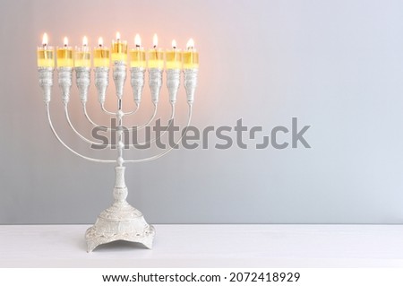 Image of jewish holiday Hanukkah with menorah (traditional candelabra) and candles