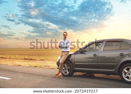 Handsome man near modern car Royalty-Free Stock Photo #2072419217