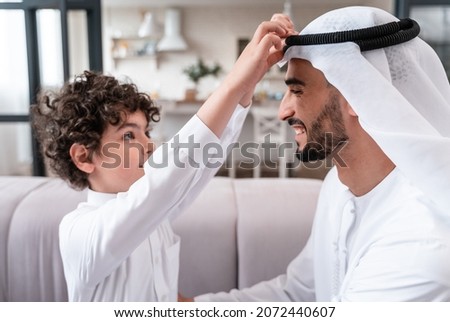 happy family spending time together. Arabian father and his son preparing to go to school Royalty-Free Stock Photo #2072440607
