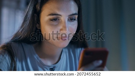 Young woman using her smartphone at home