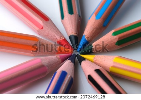 Sharpened colored pencils on a white background close-up macro photography