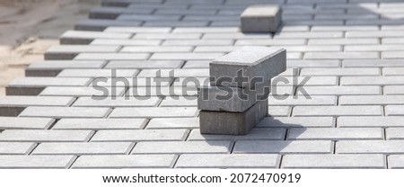 Laying paving slabs at a construction site. Technologies Royalty-Free Stock Photo #2072470919