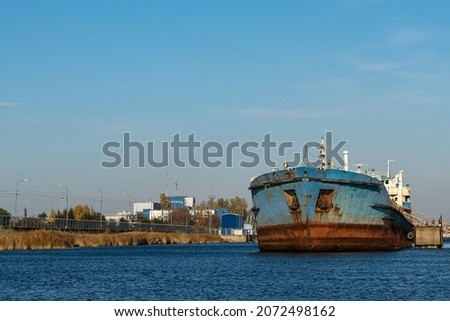 a large ship is standing at the pier. an old, rusty, huge steamer. a boat on the water. advertising picture.