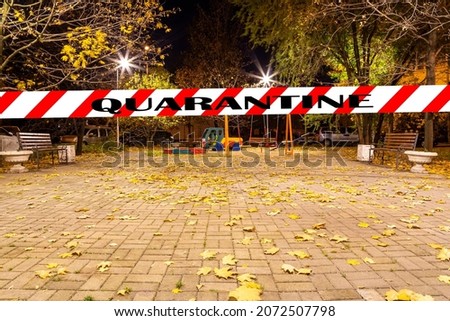 Coronavirus in Moscow, Russia. An empty playground on an autumn night in one of the residential areas. Quarantine sign. Concept of COVID pandemic and travel