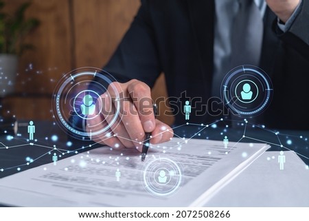 A potential employee in formal suit signing the contract to boost his career and gain new opportunities in personal growth. Concept of success. Hiring a new talented crew. Social media hologram icons