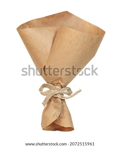 Empty craft paper wrapping cornet tied with beige canvas ribbon isolated on white Royalty-Free Stock Photo #2072515961