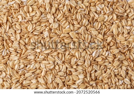 Rolled oat, oat flakes background or texture. Close up, directly above.Heap of dry rolled oats isolated. Royalty-Free Stock Photo #2072520566