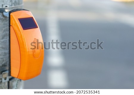 Traffic light with yellow button for pedestrians.