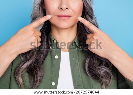 Cropped photo of cute elder white hairdo lady index mouth wear khaki shirt isolated on blue color background