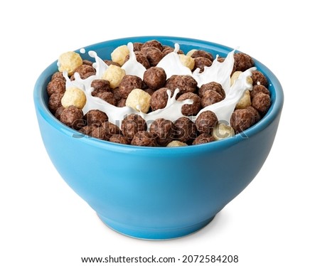 breakfast cereal with splashing milk isolated on white background. Vanilla and chocolate corn balls in blue bowl Royalty-Free Stock Photo #2072584208