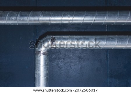 Ventilation pipe system at the ceiling of an industrial enterprise or plant premises.