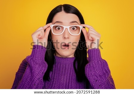 Portrait of attractive young girl hand touch glasses amazedshocked surpised news isolated on yellow color background Royalty-Free Stock Photo #2072591288