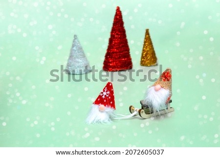 Christmas or New Year card. New Year composition. Leprechaun and sleigh on bokeh background copy space