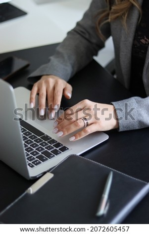 person typing on the keyboard. girl typing on the computer.office. notepad and computer. office worker. laptop on table Royalty-Free Stock Photo #2072605457