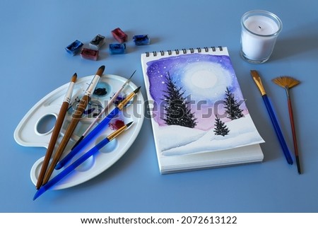 Christmas watercolor. Watercolor winter painting. Top view watercolor painting with a set of brushes, paints and palette 