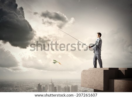 Young businessman standing on top of building and fishing