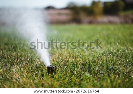 winterizing a irrigation sprinkler system by blowing pressurized air through to clear out water Royalty-Free Stock Photo #2072616764