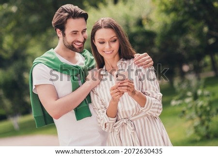 Photo of young cheerful couple happy positive smile look browse cellphone travel vacation walk outdoors Royalty-Free Stock Photo #2072630435