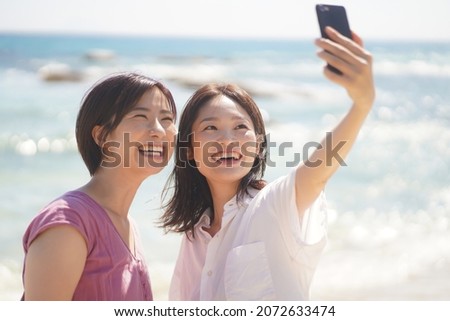 Woman taking pictures with a smartphone