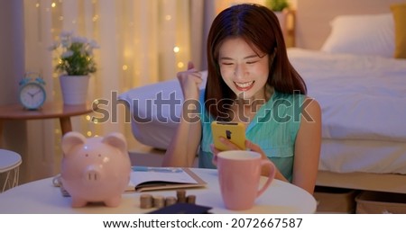 happy asian woman distributing family budget is managing domestic finances and she find something surprise about her finance at home Royalty-Free Stock Photo #2072667587