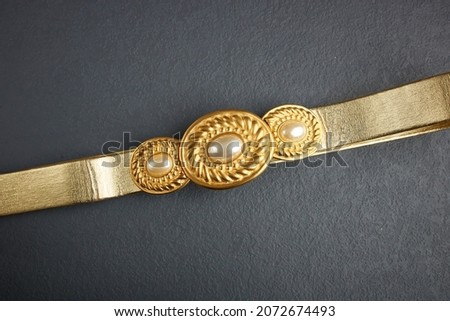 80s beautiful vintage belt buckle on gray background Royalty-Free Stock Photo #2072674493
