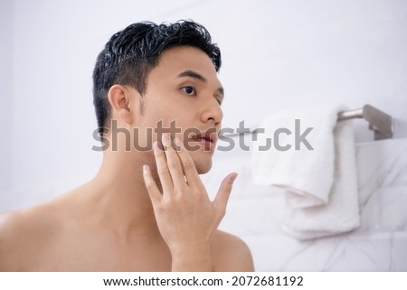 Man shaving in the bathroom. Royalty-Free Stock Photo #2072681192