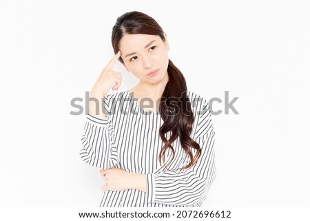 A woman in casual clothes who is in trouble due to worries Royalty-Free Stock Photo #2072696612