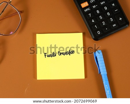 images of sticker note with funds transfer wording on a brown background