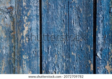 Background texture of wooden boards. The texture of the wooden surface with old blue paint.