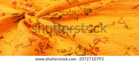 Yellow orange cotton fabric with floral print. Buy floral prints from independent artists and iconic brands. Texture, background, pattern,