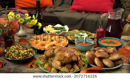 Thanksgiving holiday table. Traditional autumn dishes - turkey, homemade pumpkin pie, baked potatoes, buns. Family dinner at home. Harvest Festival