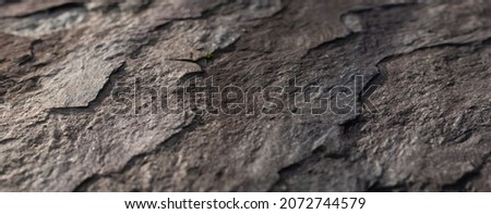 Closeup of a solid rock formation shot in perspective  with small depth. Royalty-Free Stock Photo #2072744579