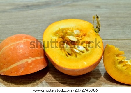 The picture shows a ripe pumpkin cut into three parts.