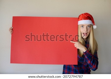 girl in a hat of Santa Claus, a red banner