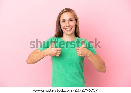 Young English woman isolated on pink background with thumbs up gesture and smiling