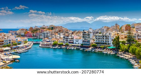 Agios Nikolaos, Crete, Greece. Agios Nikolaos is a picturesque town in the eastern part of the island Crete built on the northwest side of the peaceful bay of Mirabello.  Royalty-Free Stock Photo #207280774