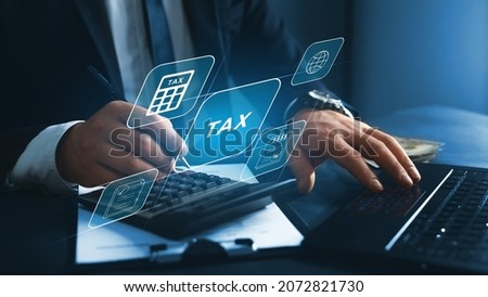 Financial research,government taxes and calculation tax return concept. Businessman using the laptop to fill in the income  tax online return form for payment.  Royalty-Free Stock Photo #2072821730