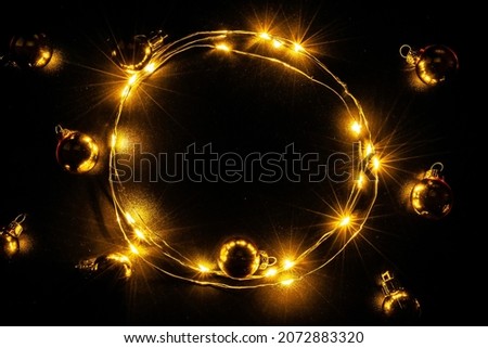 Garland christmas. Xmas party ornament decor with Golden light garland decoration, gold bulb isolated on black background. Christmas decoration and copy space for your text