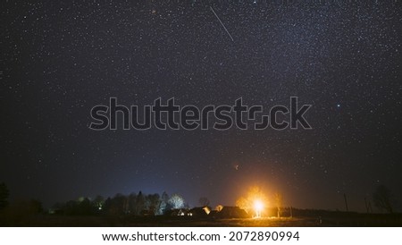 Real Night Sky Stars Above Old Village. Natural Starry Sky Above Rural Countryside Landscape In Belarus.