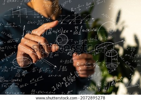 An image of a series of mathematical expressions and a hand pointing a finger at a formula. The image symbolizes the solution to the problem Royalty-Free Stock Photo #2072895278