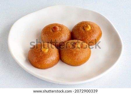 Delicious turkish sweet sekerpare on served. Traditional Turkish dessert sekerpare or badempare on a white background. Close up