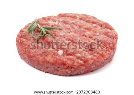 Raw hamburger patty with rosemary and salt isolated on white