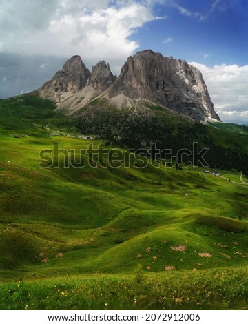 The Long Rock - Langkofel, rolling grass fields at the feet of the Langkofel Mountain range in the Dolomites