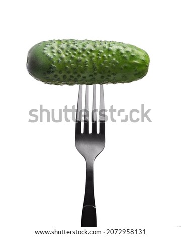 green cucumber fork on white background