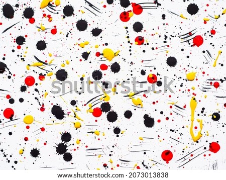 Picture painted using the technique of dripping. Mixing different colors white and red and yellow and black. Horizontal orientetion.