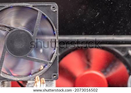 spinning 90 mm pc fan close-up with thick layer of dust and flying airborne dust particles - computer case maintenance background Royalty-Free Stock Photo #2073016502