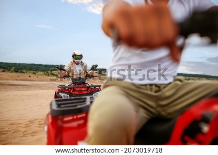Two travelers, atv riding in desert sands